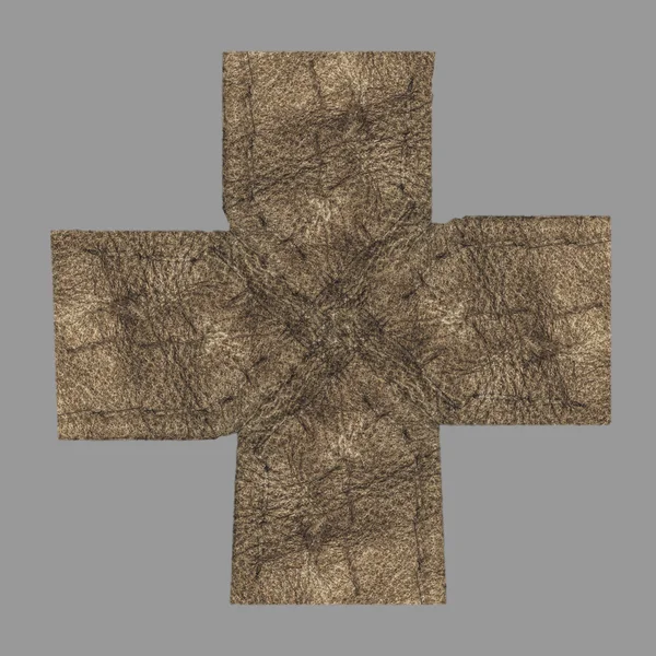 Cruz hecha a mano de cuero marrón aislado en gris —  Fotos de Stock