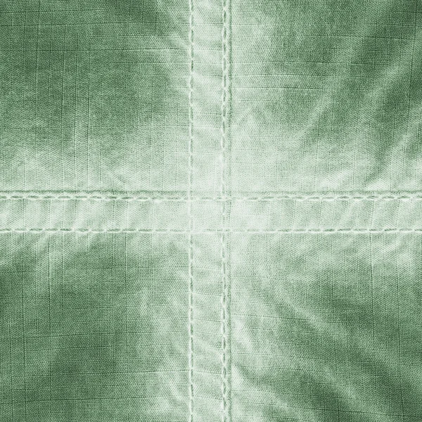Groene weefsel textuur, naden, cross — Stockfoto