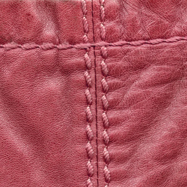 Red leather background, seams, stitches — Stock Photo, Image