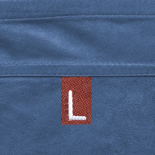 Blue leather texture closeup, seam, tag, size — Stock Photo, Image