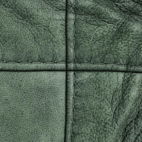Groene leder texture, naden in de vorm van het Kruis — Stockfoto