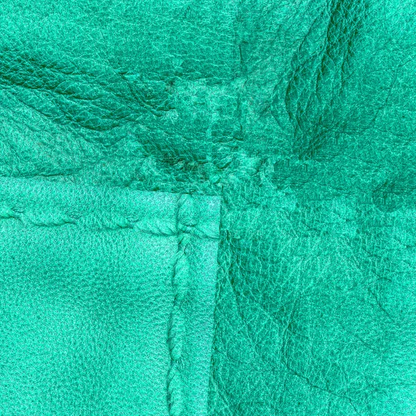 Green leather background, seam, stitch — Stock Photo, Image