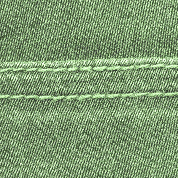 Groene denim textuur, versierd met naden — Stockfoto