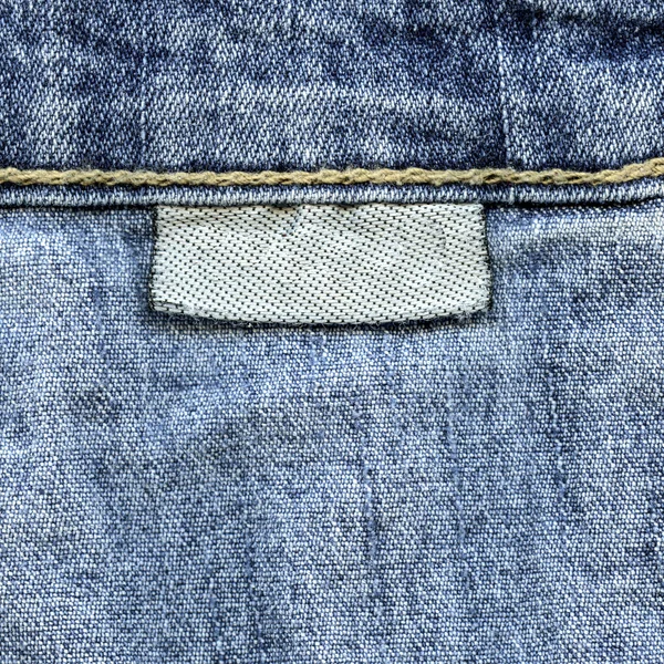 Mavi jeans doku, tekstil boş tekstil etiket — Stok fotoğraf