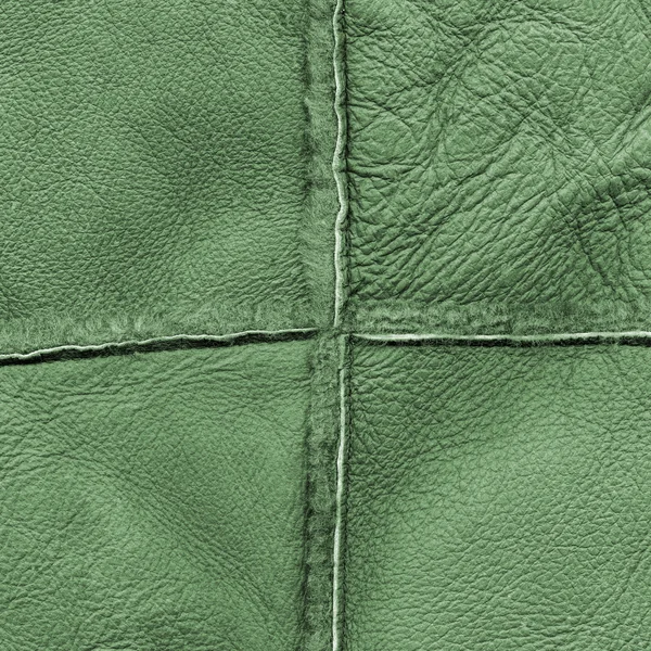 Green leather texture, seams in shape of the cross — Stock Photo, Image