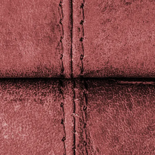 Red leather background with seams, stitches — Stock Photo, Image