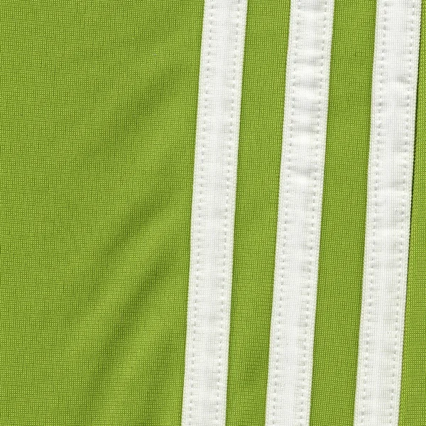 Grüne Textilstruktur, weiße Bänder — Stockfoto