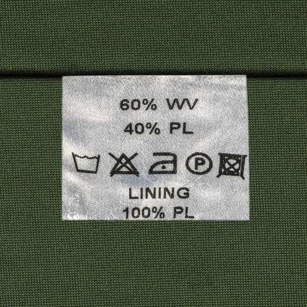 Textura de tela verde decorada con costura, etiqueta — Foto de Stock