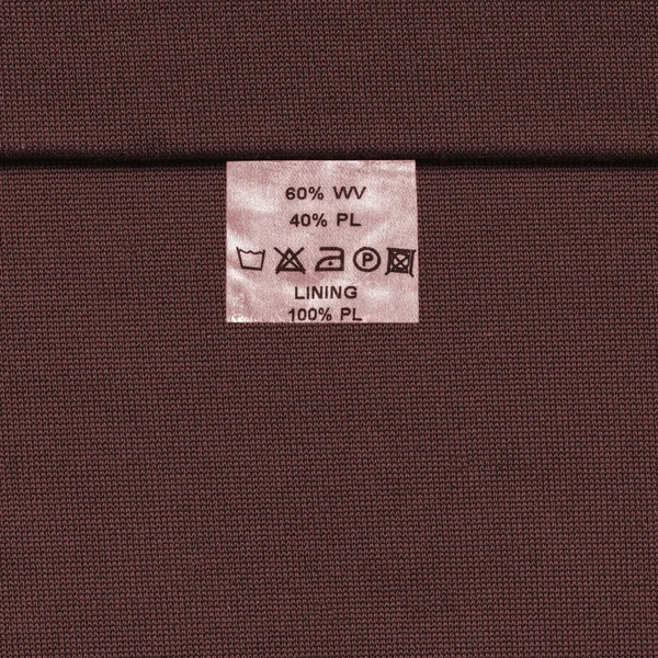 Textura de tela rojo-marrón decorada con costura, etiqueta — Foto de Stock