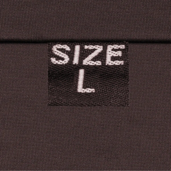 Texture textile marron, étiquette, taille — Photo