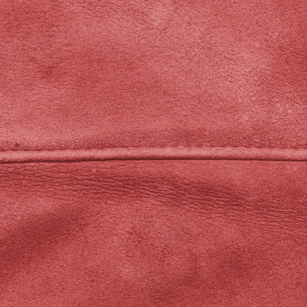 Red leather texture decorated with seam — Stock Photo, Image