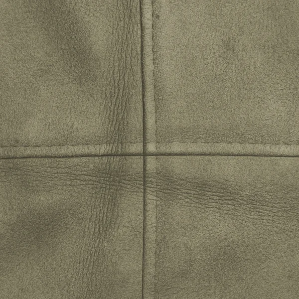 Green leather texture decorated with seams — Stock Photo, Image