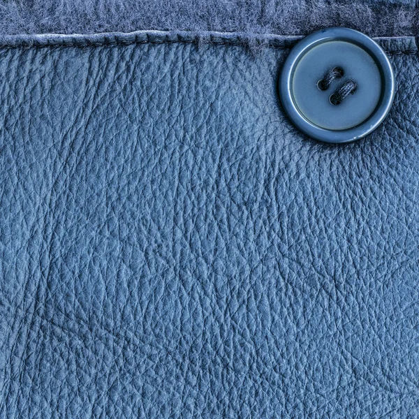 Fondo de cuero azul decorado con costura y botón —  Fotos de Stock