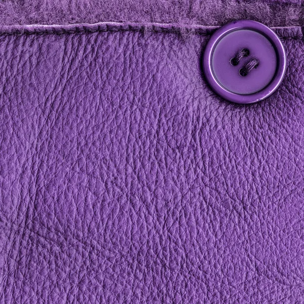 Violet leather background decorated with seam and button — Stock Photo, Image