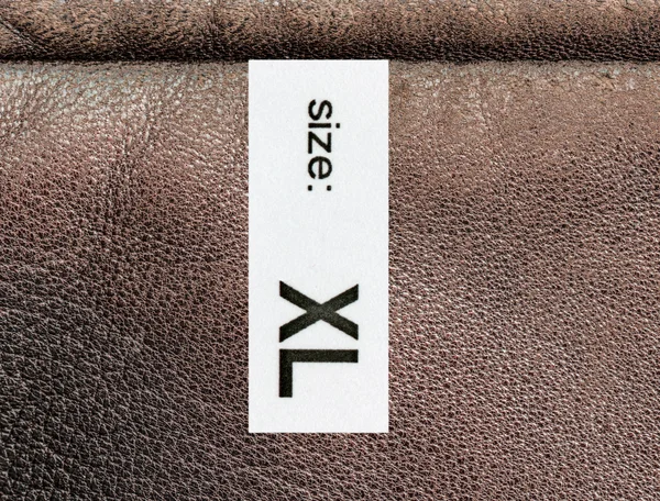 Brown  leather texture, textile tag,size — Stock Photo, Image