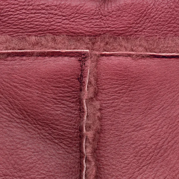 縫い目で飾られた赤い革バック グラウンド — ストック写真