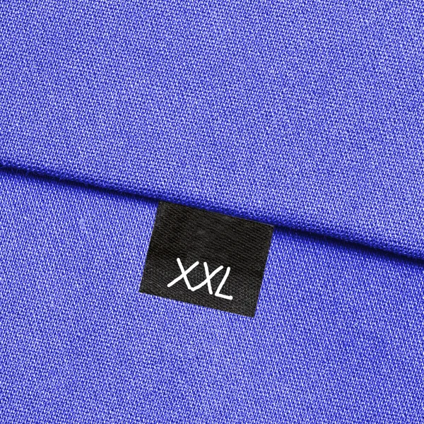 Texture de tissu bleu, couture, étiquette — Photo