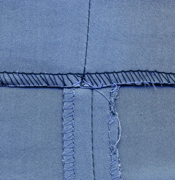 Costura del pantalón lado equivocado, fondo textil azul —  Fotos de Stock