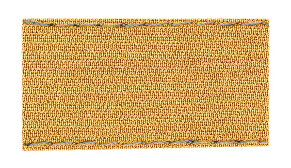 Etiqueta têxtil amarelo-marrom em branco — Fotografia de Stock