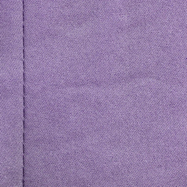 Violet stof textuur versierd met naad — Stockfoto