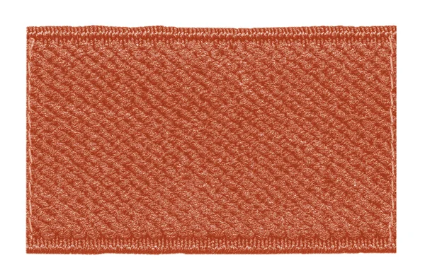 Etiqueta textil roja en blanco aislada sobre fondo blanco — Foto de Stock