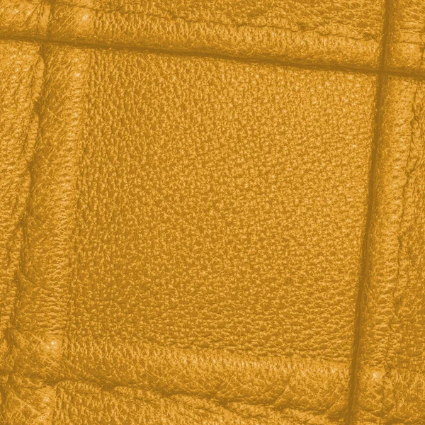 Yellow leather texture decorated with seams — Stock Photo, Image