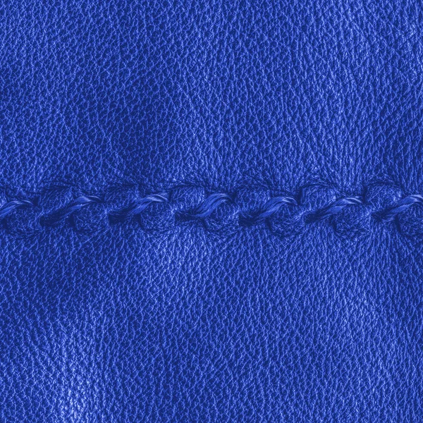 Blue leather texture decorated with seam — Stock Photo, Image