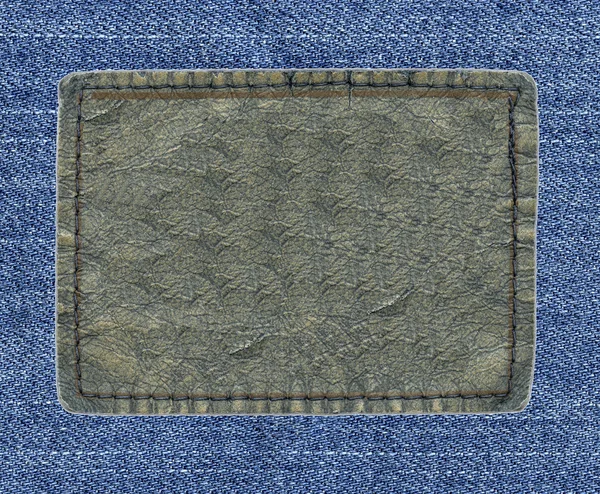 Blank leather label on blue denim background — Stock Photo, Image
