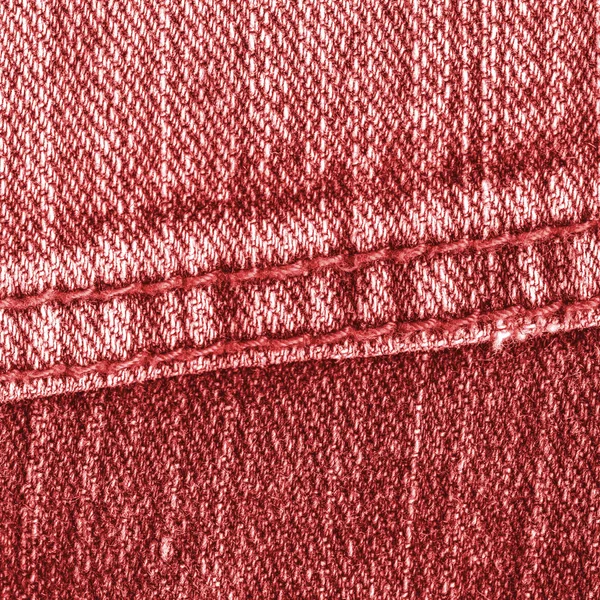 Красный фон джинсы украшены швом — стоковое фото