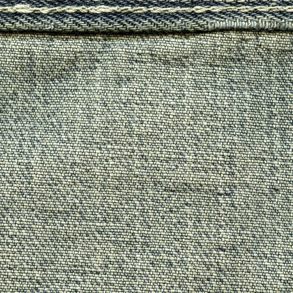 Texture of old blue jeans wrong side, seam — Stock Photo, Image