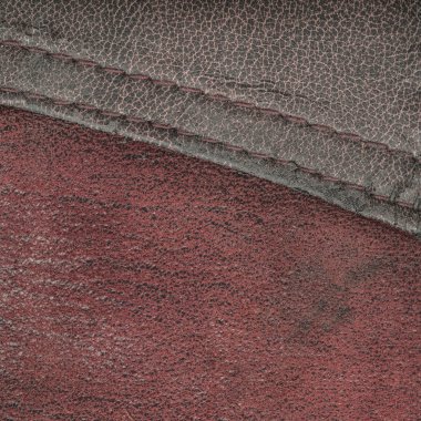 kırmızı-kahverengi arka plan birlikte dikişli deri parçaları