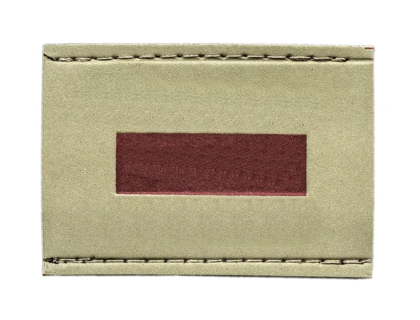 Étiquette en cuir beige décorée avec insert rouge — Photo