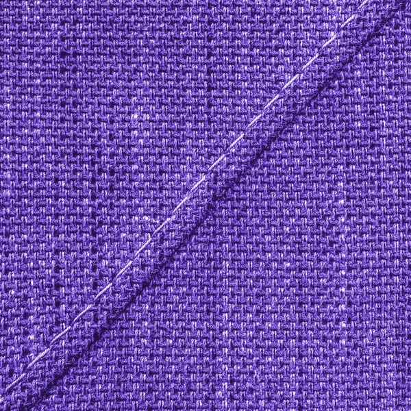 Violet fabric texture close seup, seam.stitches — стоковое фото