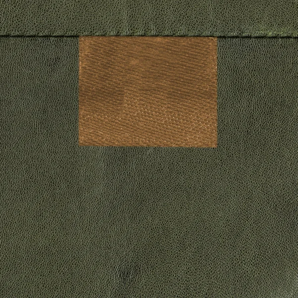 Tomt-brunt märke på grönt läder bakgrund — Stockfoto