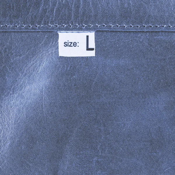 Blue leather texture, seam, stitch, tag, size — Stock Photo, Image