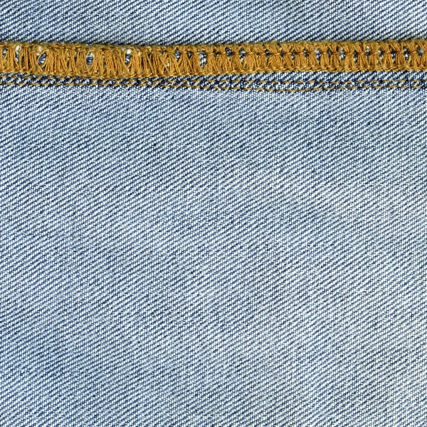 Текстура синей джинсы крупным планом, шов — стоковое фото