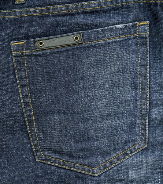 Blue jeans back pocket on jeans background — Stock Photo, Image