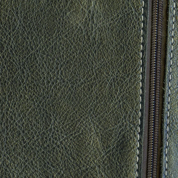 Dark green leather background decorated with zipper — Stock Photo, Image