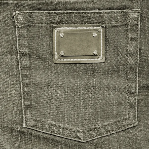 Bolso traseiro de jeans cinza-marrom, etiqueta — Fotografia de Stock