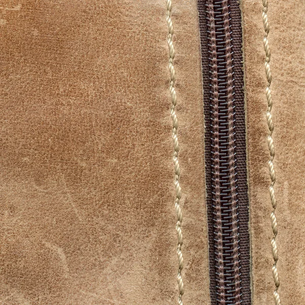 Beige leather background decorated with  zipper — Stock Photo, Image