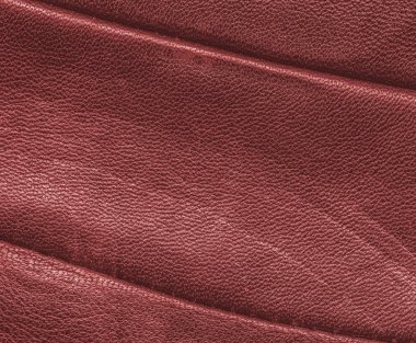 Kırmızı eski deri doku dikişleri ile dekore edilmiştir.     