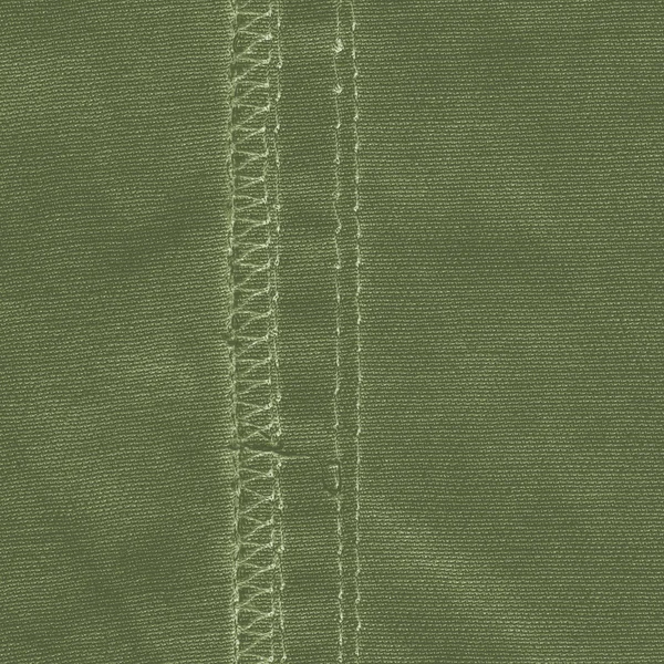 Zelený textilní textur zdobené švy — Stock fotografie