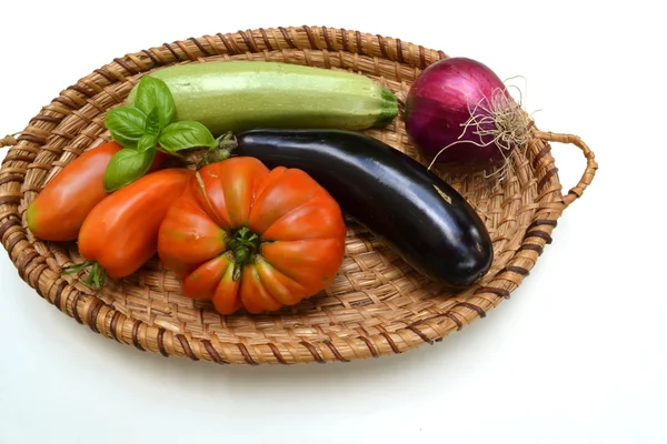 Basket with vegetables in front on white background — Stock Photo, Image