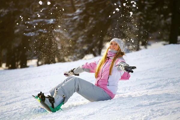 Happy smiling girl with lifted hands  on snowboard — Stock Photo, Image