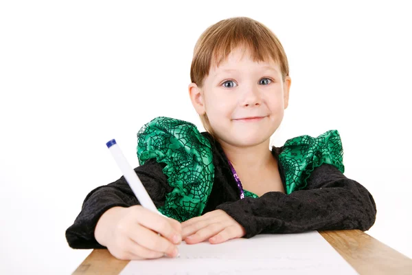 Little girl in beautiful green dress with pen in hand — Stock Photo, Image