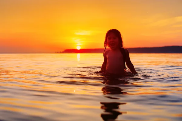 Meisje lachen en huilen in de spray van golven op zee — Stockfoto