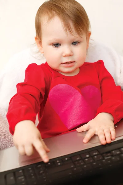 Cute baby looking into the laptop — Stock Photo, Image
