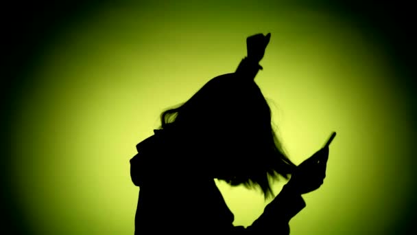 Girl with a phone dancing. silhouette — Video Stock