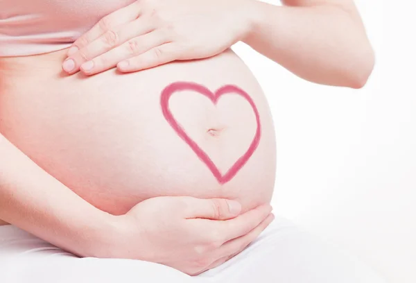 Beau ventre de jeune femme enceinte attrayante sur fond blanc — Photo