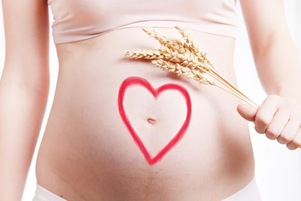 Beautiful belly of young attractive pregnant woman over white background — Stock Photo, Image